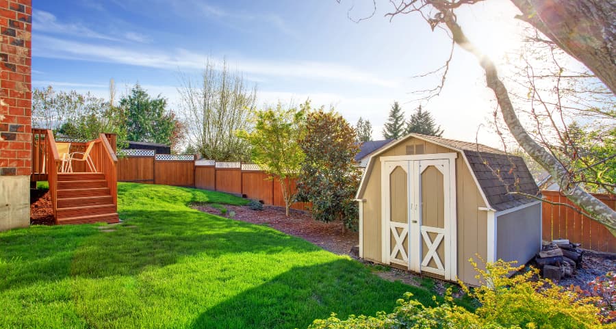 Fenced backyard with storage shed in Fayetteville